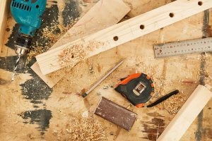 Top view background of tools and wood lying on table in carpenters workshop, copy space