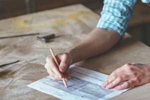 Young master in an apron in carpentry