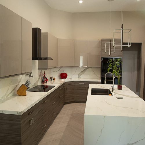 Bold Modernity: A wide shot of the modern kitchen, showcasing the captivating blend of custom high-gloss grey and textured Palisandro Grey cabinetry, defining a truly unique space.